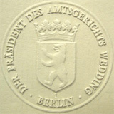 Ein Abdruck einer Prägepresse - zu sehen ist ein Siegel